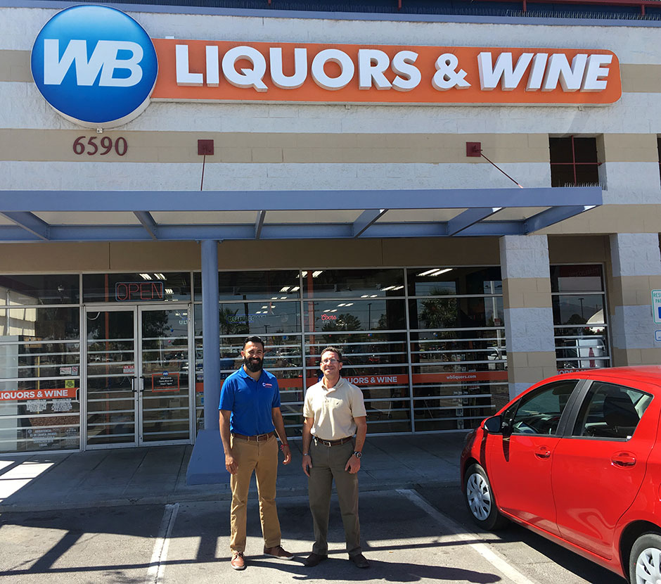 Picture of Miguel Valenzuela, El Paso District Manager , WB Liquors & Wine & Leiferman Enterprise President Jacob Leiferman with store sign